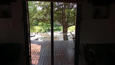 an open door to a porch with a view of a tree at El Solar in La Bolsa