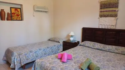 a room with two beds with pink towels on them at El Solar in La Bolsa