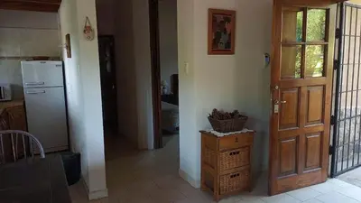 a kitchen with a refrigerator and a wooden door at El Solar in La Bolsa