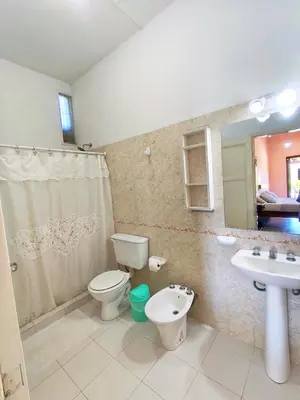 a bathroom with a toilet and a sink at Mirador del lago apart y cabañas- exclusivo adultos in Las Rabonas