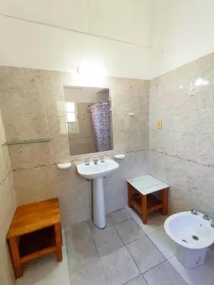 a bathroom with a sink and a mirror and a toilet at Mirador del lago apart y cabañas- exclusivo adultos in Las Rabonas