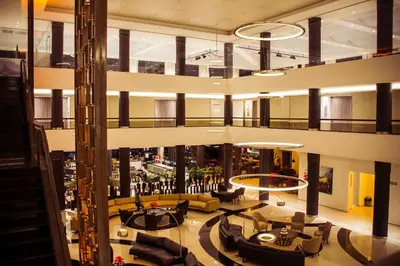 a lobby of a building with couches and tables at Eleton Resort & Spa in Villa Carlos Paz