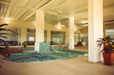 an indoor pool with a fountain in a building at Eleton Resort & Spa in Villa Carlos Paz