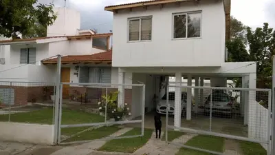 a man standing in front of a house at Departamento Carlos Paz in Villa Carlos Paz