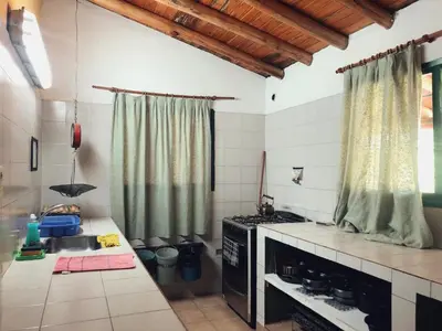 a kitchen with a sink and a stove top oven at Granja El Aromo in Las Calles