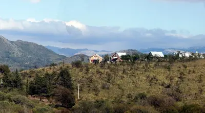 a group of houses sitting on top of a hill at Cabañas del Peñasco in Alpa Corral
