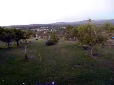 a field with trees and a city in the distance at Cabañas del Peñasco in Alpa Corral