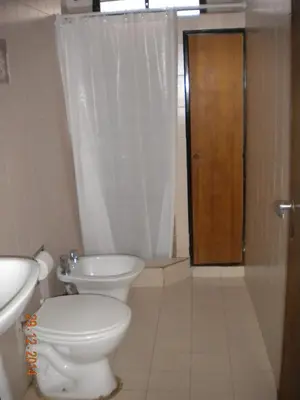 a bathroom with a toilet and a sink and a shower at Chalet Carlos Paz in Villa Carlos Paz