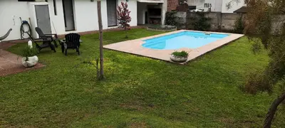 a swimming pool in the yard of a house at Chalet Carlos Paz in Villa Carlos Paz