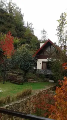 a small house with a bench in front of it at Arroyo Escondido in La Cumbrecita