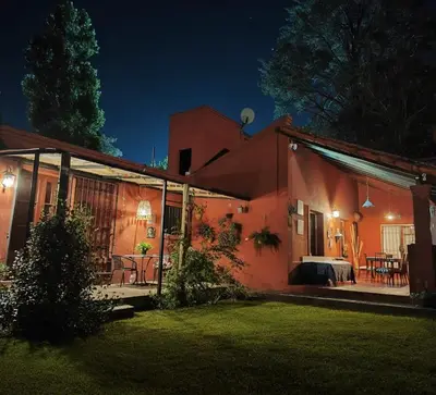 a small house with a patio at night at Qui Home in Cordoba