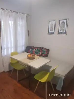 a room with a table and chairs and a couch at Qui Home in Cordoba