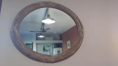 a mirror hanging on a wall with a ceiling at Qui Home in Cordoba