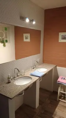 a bathroom with two sinks and a large mirror at Qui Home in Cordoba