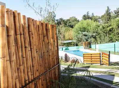 a wooden fence in front of a pool at Terralagum in Villa Parque Siquiman