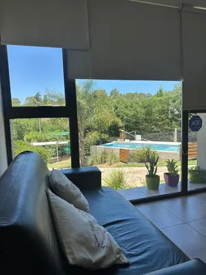 a couch in a living room with a view of a pool at Terralagum in Villa Parque Siquiman