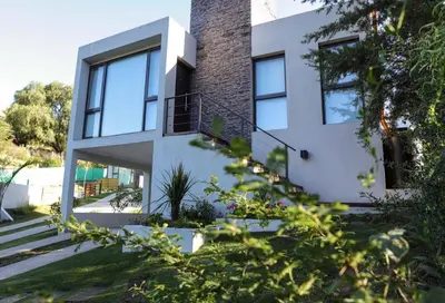 a white house with glass windows and stairs at Terralagum in Villa Parque Siquiman