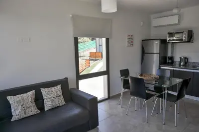 a living room with a couch and a table with chairs at Terralagum in Villa Parque Siquiman