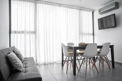 a living room with a table and chairs and a couch at Terralagum in Villa Parque Siquiman