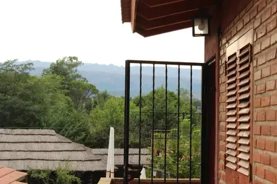 an open door to a balcony with a view at La Posada Del Poeta in Mina Clavero