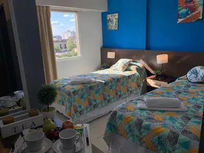 a hotel room with two beds and a table with fruit at Novum Suites in Cordoba