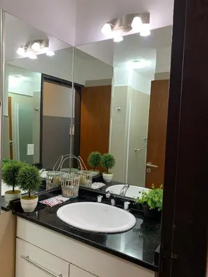 a bathroom with a sink and a large mirror at Novum Suites in Cordoba