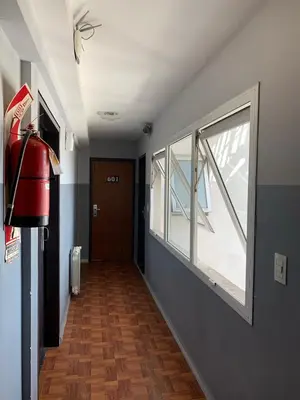 a hallway with a large window and a door at Novum Suites in Cordoba