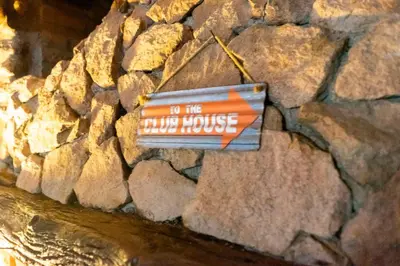 a sign on the side of a rock wall at Posada de Nono in Nono