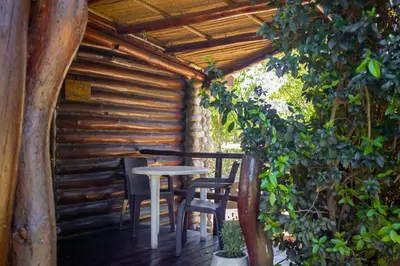 a table and chairs on a wooden deck at Posada de Nono in Nono