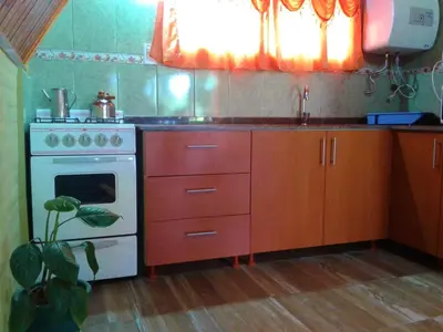 a kitchen with a white stove and a sink at Cabanas Junto al Rio in Panaholma