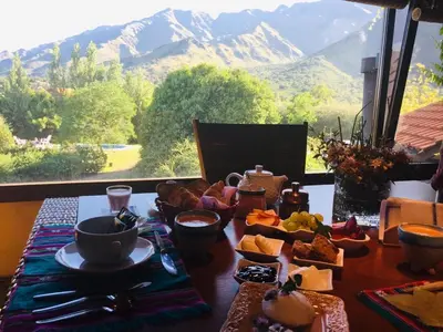 a table with food and a view of a mountain at Zolara Di Merlo in Merlo