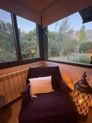 a bench with a pillow in a room with windows at Zolara Di Merlo in Merlo
