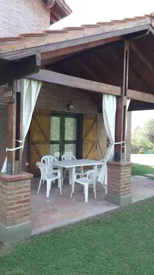 a patio with a table and chairs on a house at Chalets Andalgala in Merlo