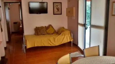 a living room with a couch with a yellow blanket at Chalets Andalgala in Merlo