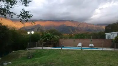 a view of a mountain range with a swimming pool at Chalets Andalgala in Merlo