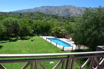 a view of a yard with a swimming pool at Chalets Andalgala in Merlo