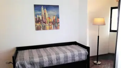 a bedroom with a bed and a painting on the wall at Céntrico, Confortable y Cómodo in Cordoba