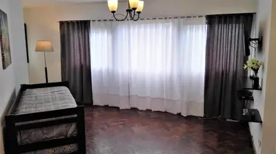 a bedroom with a bed and a large window at Céntrico, Confortable y Cómodo in Cordoba