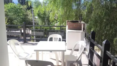 a white table and chairs on a patio at Departamento Amarillis in Mina Clavero