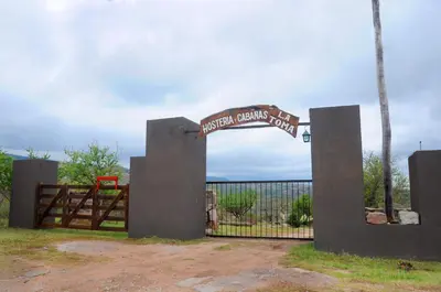 a gate with a sign that reads imperial academy road at LA TOMA Complejo de Montaña - Cabañas y Habitaciones en Hosteria in Mina Clavero