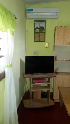 a room with a table with a television and a window at El Chaparral Villa Dolores Traslasierra 2 in Piedra Pintada