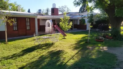 a house with a playground in the yard at El Chaparral Villa Dolores Traslasierra 2 in Piedra Pintada