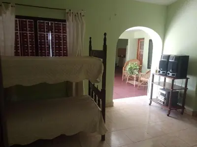 a bedroom with a bed and a living room at El Chaparral Villa Dolores Traslasierra 2 in Piedra Pintada