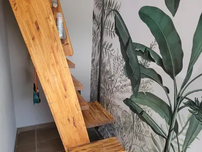 a wooden ladder next to a wall with a plant at Aqua Duplex in Villa Carlos Paz