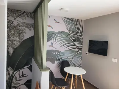 a room with a table and two chairs and a wall mural at Aqua Duplex in Villa Carlos Paz