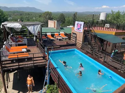 a group of people swimming in a swimming pool at Altos del Mayu Cabañas - Alojamiento in San Antonio de Arredondo