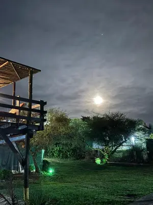 a garden at night with the moon in the sky at Altos del Mayu Cabañas - Alojamiento in San Antonio de Arredondo