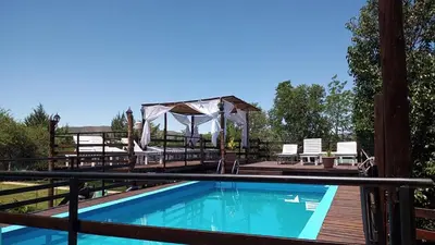 a pool on a deck with a gazebo at Altos del Mayu Cabañas - Alojamiento in San Antonio de Arredondo