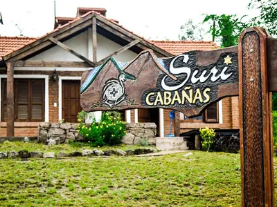 a sign in a yard in front of a house at Suricabanias in Villa Yacanto