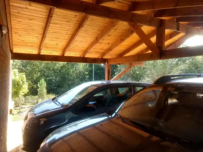 a car parked in a garage with a wooden roof at Suricabanias in Villa Yacanto